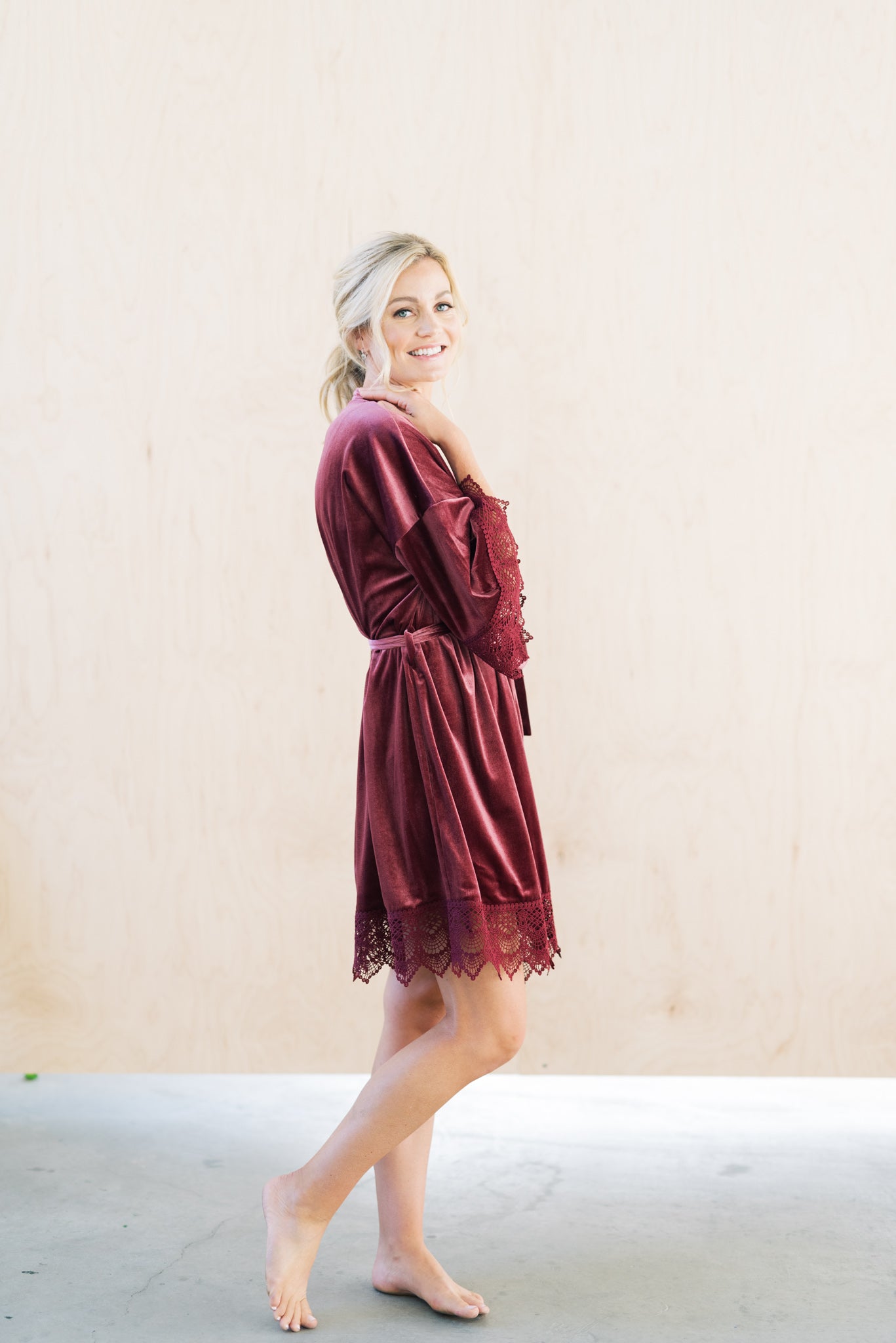 Bride wearing a mauve velvet and lace robe